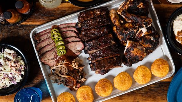A tray of brisket, other meats and cornbread from Dinosaur Bar-B-Que