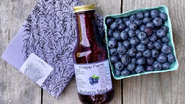Products from the Ithaca Farmer's Market: A designed washcloth, blueberry sauce and blueberries