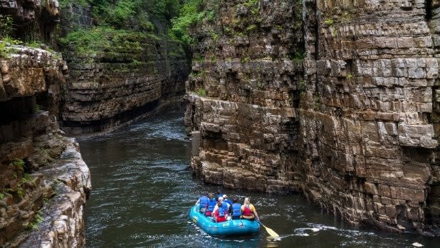People in a blue raft in Ausable Chasm