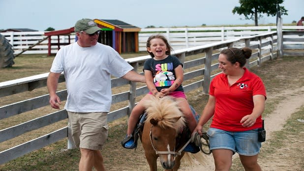 Little girl rides a pony at Old McDonald's Farm in Sackets Harbor, NY