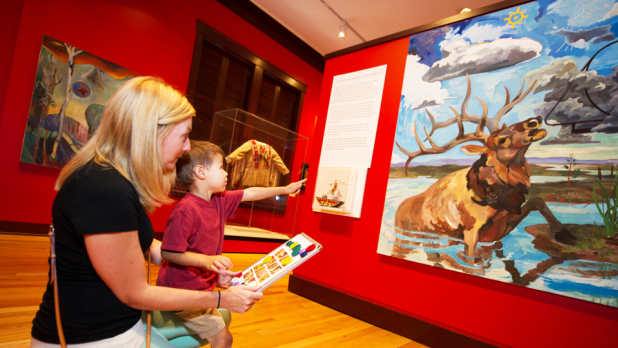 mom and child looking at a historical paining together