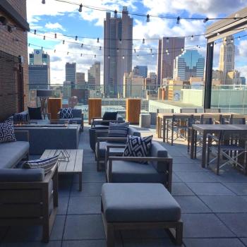 City skyline views and chic patio furniture on stylish rooftop bar at Goodale Station at Canopy by Hilton