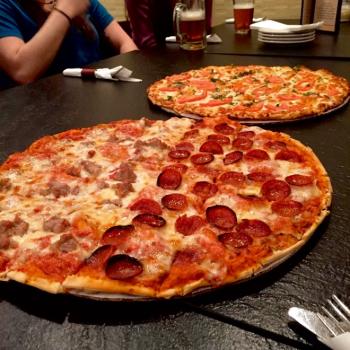 Pizza pies with various toppings at Iacono's Pizza
