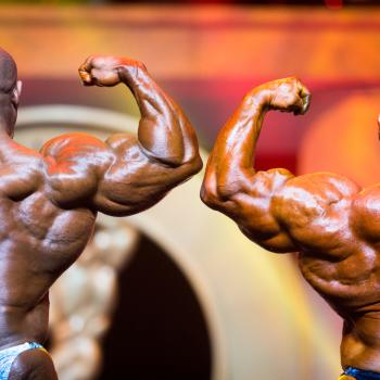 Rear view of two bodybuilders flexing their arms in the Arnold Sports Festival
