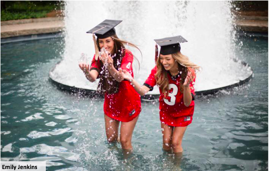 2 students wearing graduation caps in the UGA fountain