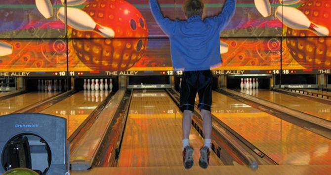Celebrating after a strike at The Alley Bowling