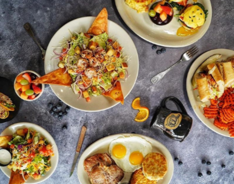 An assortment of breakfast/brunch dishes from The Toasted Yolk