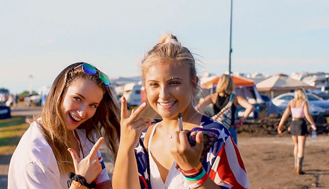 Two Heartland Stampede attendees enjoy some downtime while camping at the music festival.