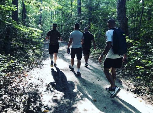 4 Men walking down the Bald Cypress Trail in Virginia Beach