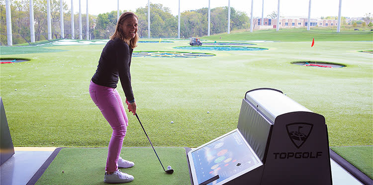 Happy golfer tees up at Topgolf in Overland Park, KS