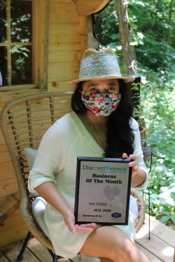Portrait photo of Claire Benjamin holding July 2020 BoM award
