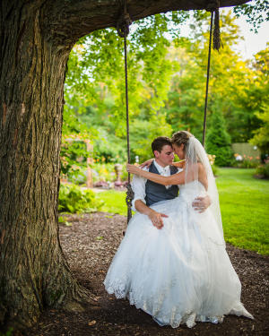 The Heltons used the beautiful Avon Gardens outdoor venue for their wedding. (Photos courtesy of Rogue Images Photography) Helton couple on swing at Avon Gardens on wedding day