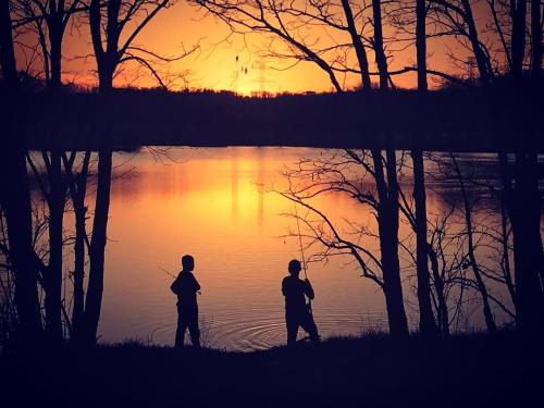 People fishing at sunset of Sam Peden Park