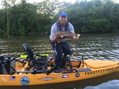 Man kayak fishing on one of Fort Wayne, Indiana's three rivers.