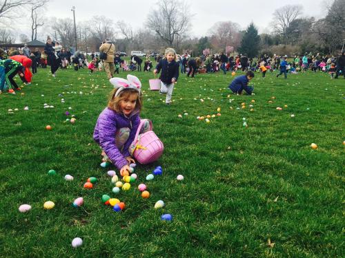 A bunch of kids running to collect easter eggs