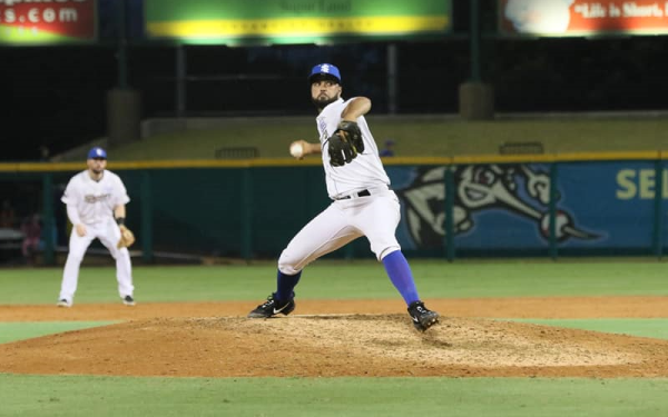 Skeeters pitcher winding up at a Sugar Land Skeeters minor league baseball game.