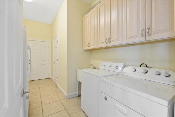 Laundry room with extra refrigerator