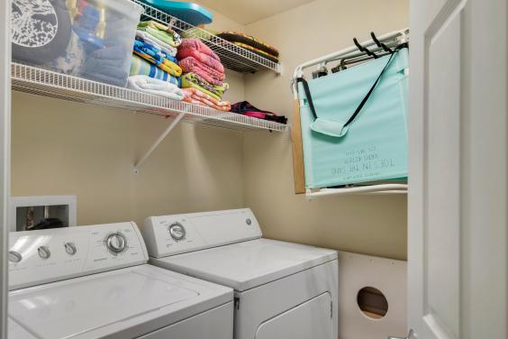 Full Size washer and dryer; laundry room with beach towels, coolers, extra chairs, & beach toys