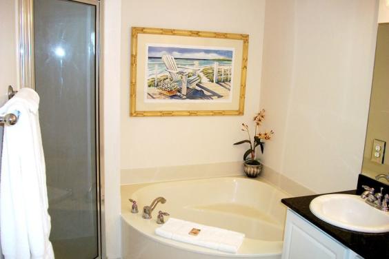 Master Bath with double vanity, soaking spa tub and separate tiled shower.