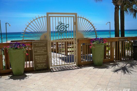 View from pool deck, keypad lock on gate to beach