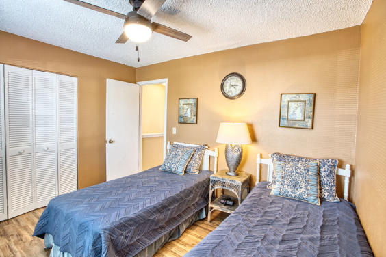 Second bedroom is cozy and bright with two twin beds!