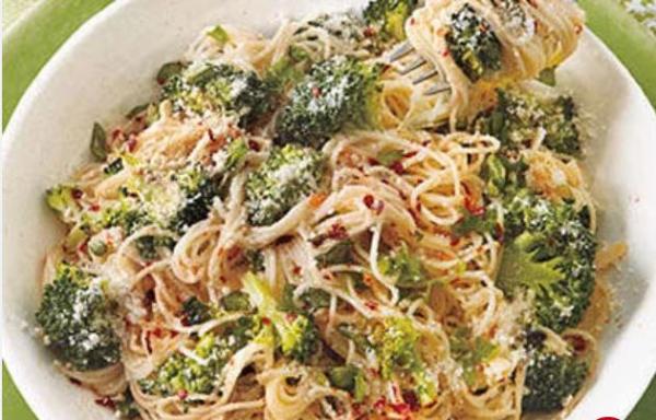 A bowl of angel-hair pasta is mixed with broccoli and Parmesan cheese.