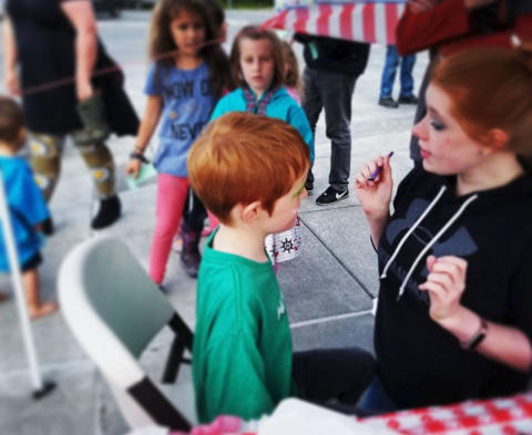 Facepainting for children at a festival