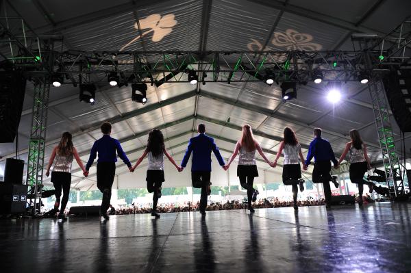 A troupe of Irish Dancers performing on stage at the Dublin Irish Festival.