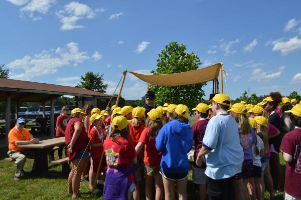 A student group stands together listening to a tour guide