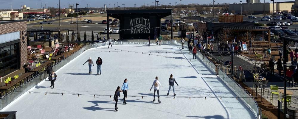 People skate on the ice rink setup at Chicken N Pickle