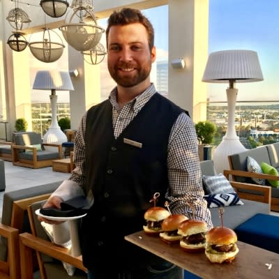 A server with burgers at Hive and Honey