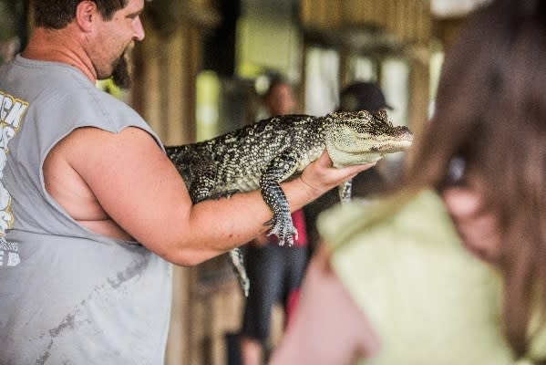 Man holding a gator