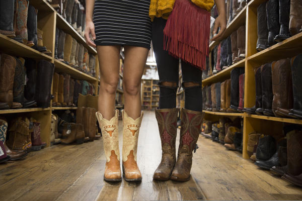 Two women model boots at Allens Boots on South Congress