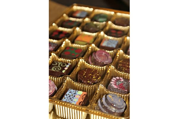 At Bruges Chocolaterie, artisan chocolates are hand painted by Culinarian Christina Miles.