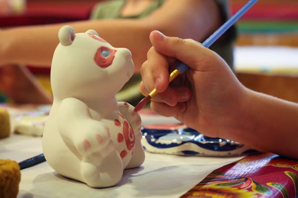 Painting a ceramic bear.