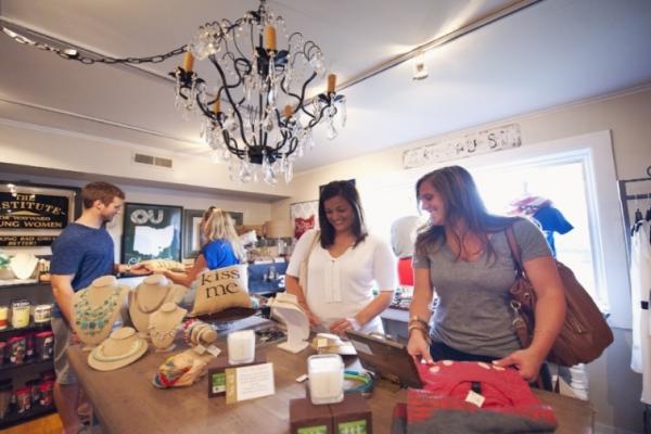 Two girls and a boy shopping at table at Boho 72 Boutique in Historic Dublin