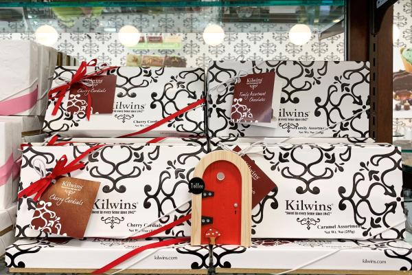 Red Fairy Door in front of Kilwins chocolate boxes