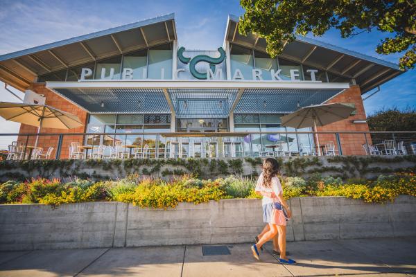 A woman walks by the Oxbow Public Market in Napa.