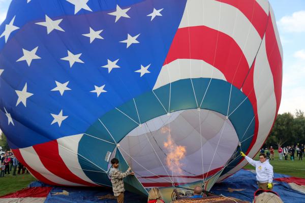 A hot air balloon being inflated with a large flame
