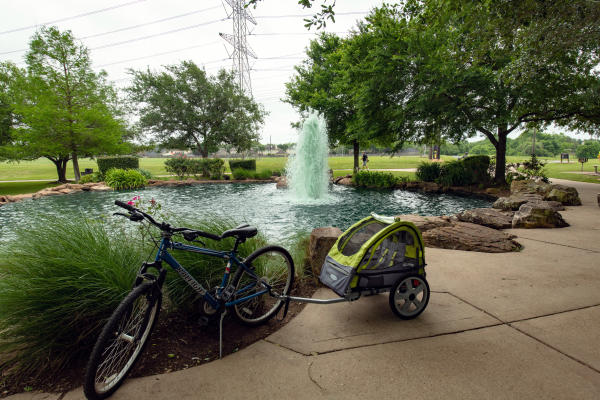 Bike and rickshaw in front of the water feature at Oyster Creek Park.