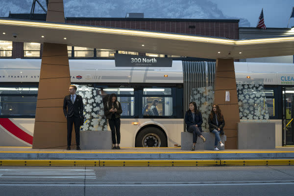People Standing at UVX Bus Stop