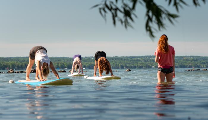 People doing yoga on paddleboards People doing yoga on paddleboards