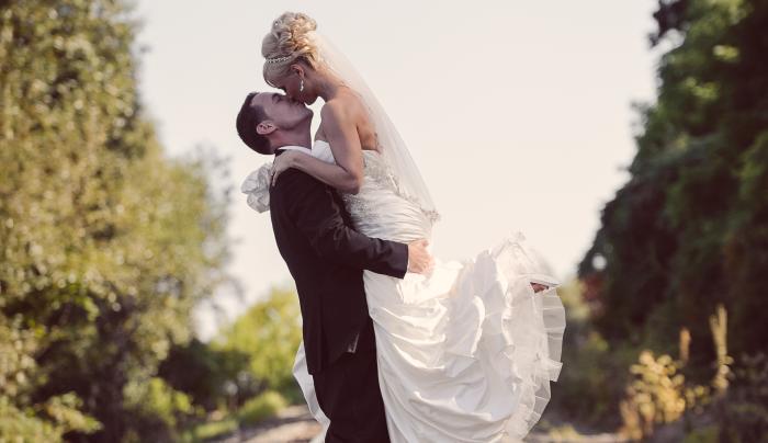 Bride and Groom embracing on railroad tracks that cross near Belhurst Castle Bride and Groom embracing on railroad tracks that cross near Belhurst Castle