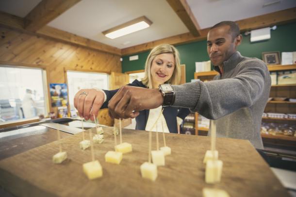 couple reaching for cheese at Gunn's HIll