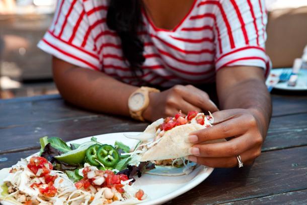 woman eating tacos