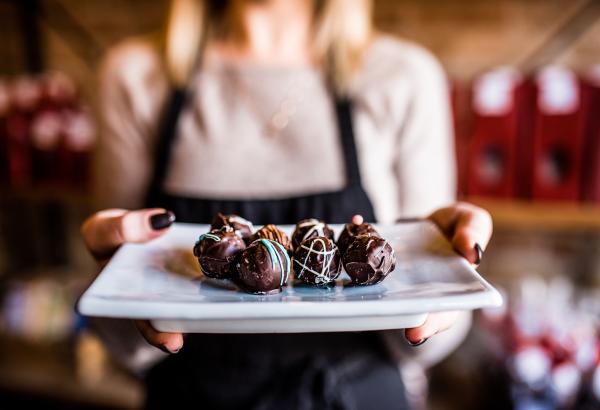 woman holding chocolates on plate