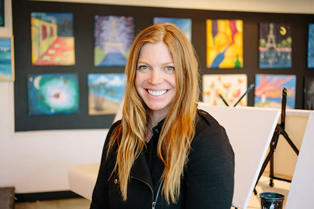 Paint Mixer owner Jill Johnson sitting in studio smiling at camera