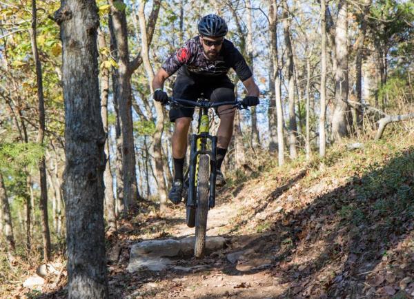 A man riding a mountain bike down a trail