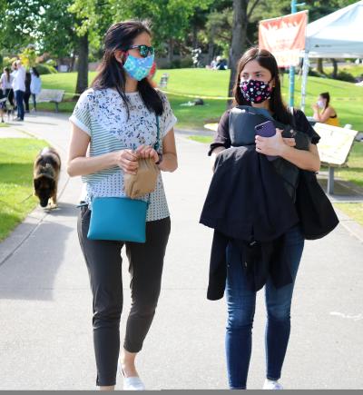 Two women walking in Marina Park at the Kirkland Wednesday Market