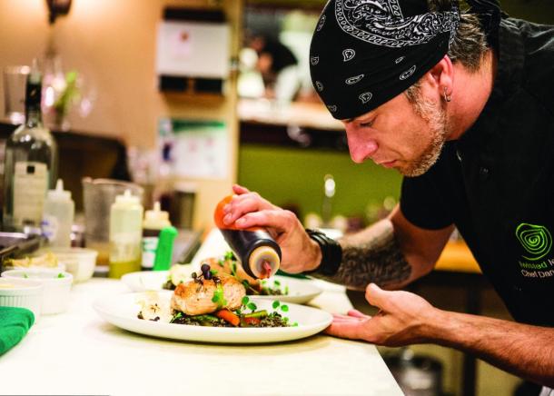 A chef from Twisted Lemon preparing a dish